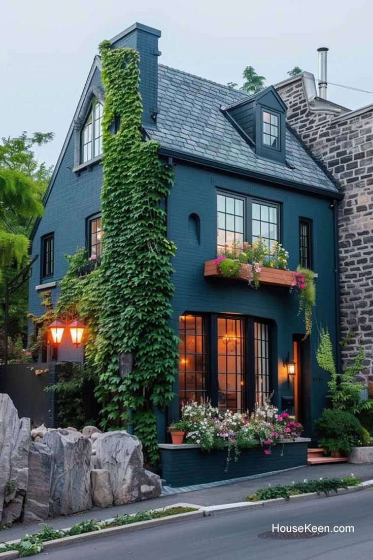 This dark blue brick house features an elegant ivy wall and 