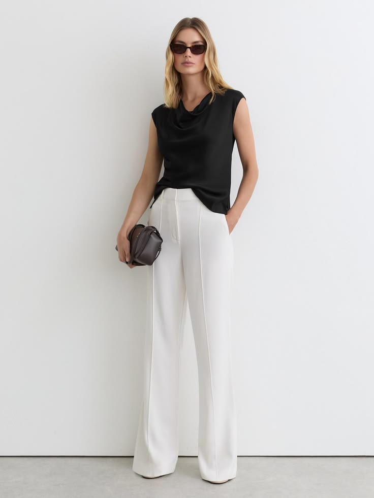The Black Cate top is crafted in smooth silk with a softly d