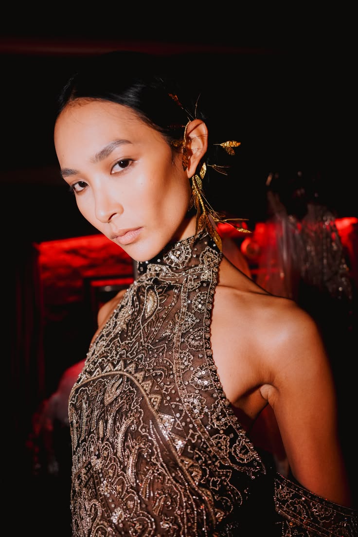 An intricately hand-embroidered halter gown grounded by a de