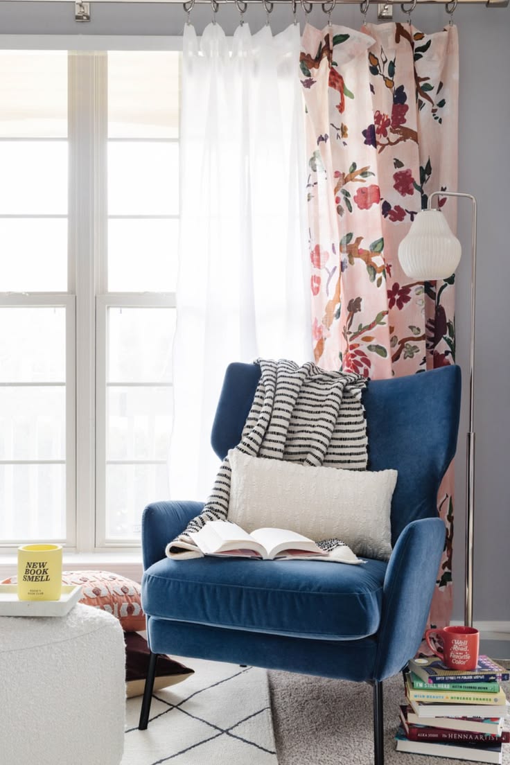 This cozy reading nook pairs a plush blue accent chair with 