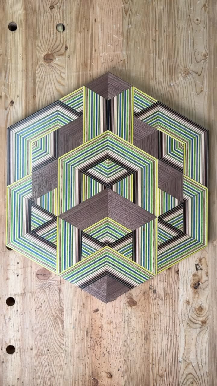 Finishing touches on a batch of weave wall art made from rec