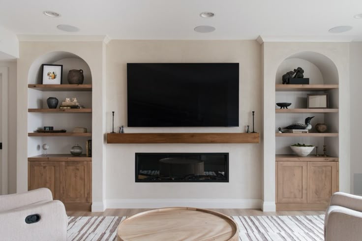 Custom cabinetry with arch detail around basement fireplace 