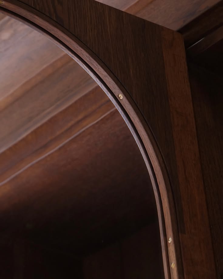 An elegant detail that allows the glass in these arched cabi