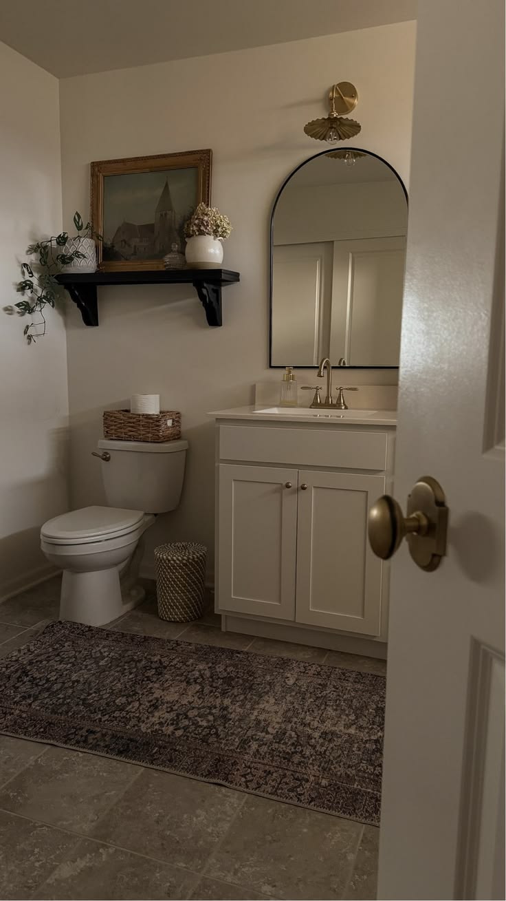 Brighten a small bathroom with a pristine toilet and sink, m